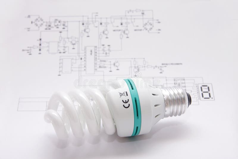 A better light bulb. The light bulb saving up energy lays on the electrotechnical scheme stock photo