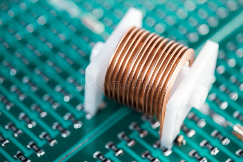 Close-up metal copper wire put on a plastic cork. Lies on a green microcircuit. Concept for the production of powerful graphics cards and computers and for stock photos