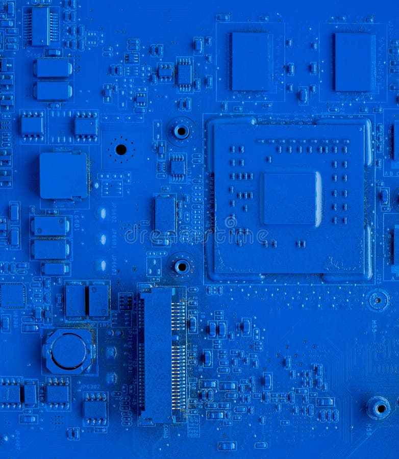 Computer motherboard. Classic blue background with pc backdrop, close up. Single color microchip royalty free stock photos