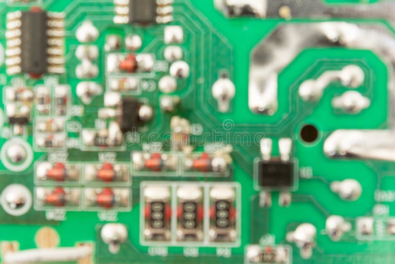 Defocused abstract background of green circuit board with microcircuits stock images