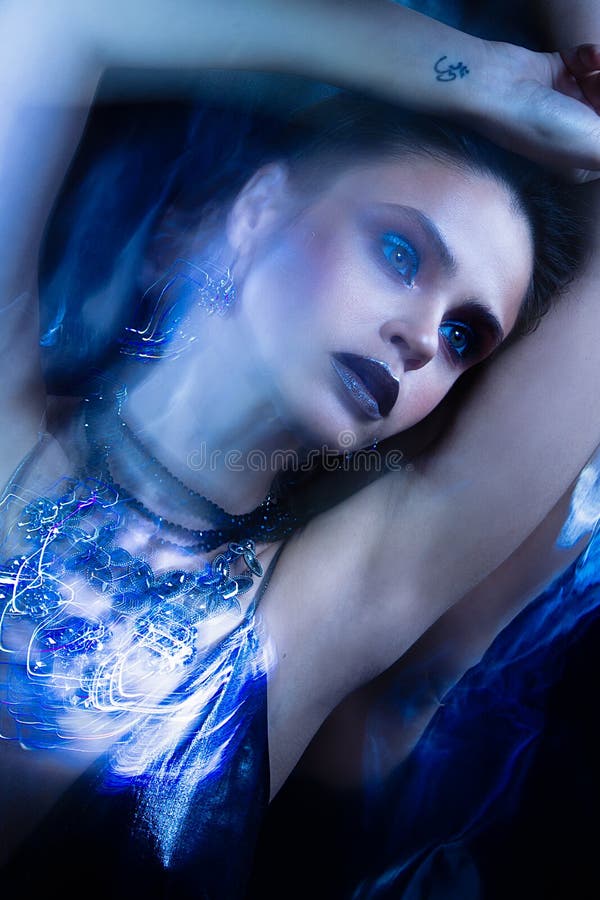 Fashion studio portrait of woman with jewelry. Mix light scheme royalty free stock photo