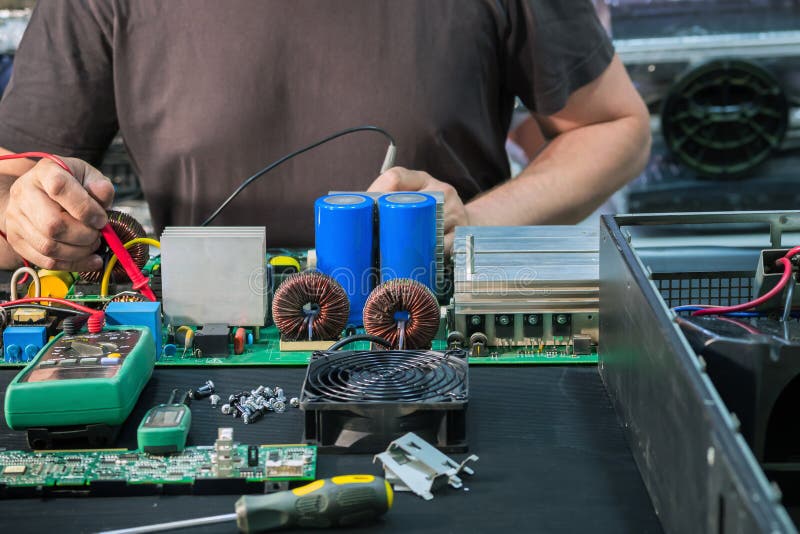 Fault diagnosis and repair of a powerful uninterruptible power supply unit. In the service center royalty free stock image