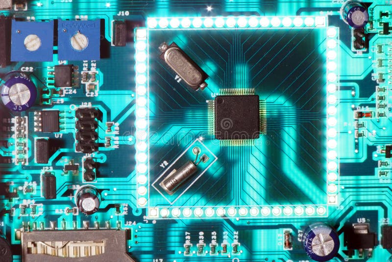 Electronic chip circuit board glowing. A functional and working electronic circuit board with many components like diodes, transistors, switches, resistors stock photography