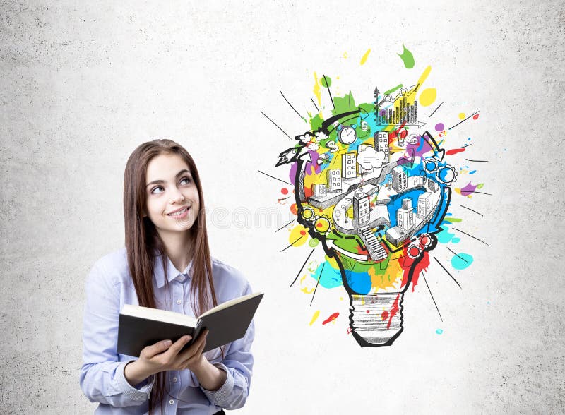 Happy college student, light bulb scheme. Young businesswoman in a blue shirt wearing a dark red lipstick is standing with an open book near a concrete wall stock image