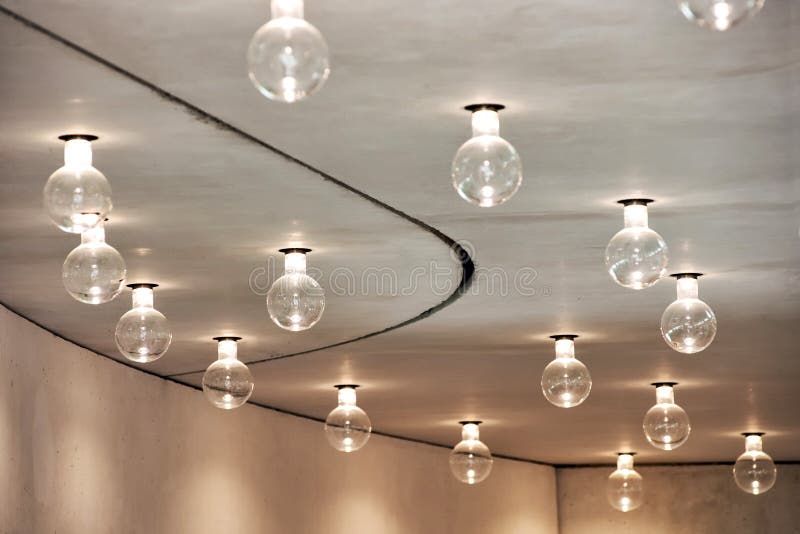 Lightbulbs Arranged in Pattern in Room Ceiling. Architectural Detail of Room Lighting Scheme - Close Up of Exposed Globe Light Bulbs Hanging in Pattern from royalty free stock photo