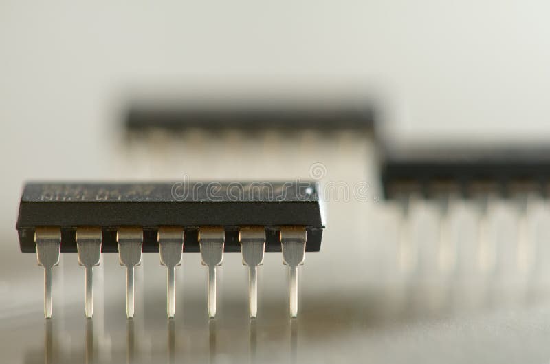 Microcircuits. Close up macro photo of 14 pin microcircuits royalty free stock photos