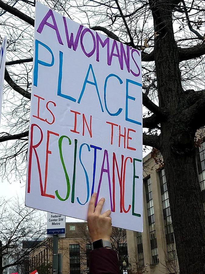 Multicolored letters printed on a sign from the original Women`s March January 2017. A Woman`s place is in the resistance. Multicolored text printed in bold stock photography