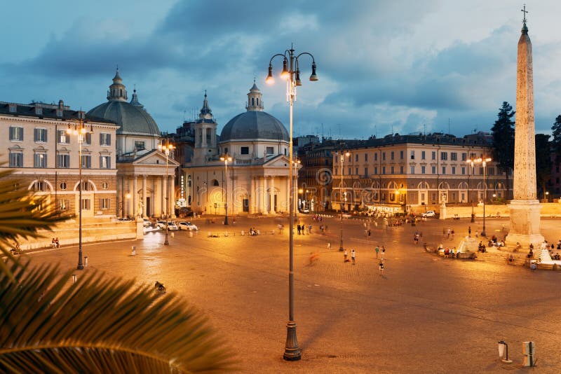 Night view to Piazza del Popolo in Rome, Italy. Night view of people walking and resting ono Piazza del Popolo in Rome, Italy.  Church of Santa Maria del Popolo royalty free stock images