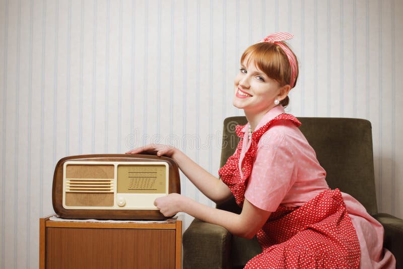 Retro house wife listening to the radio royalty free stock image