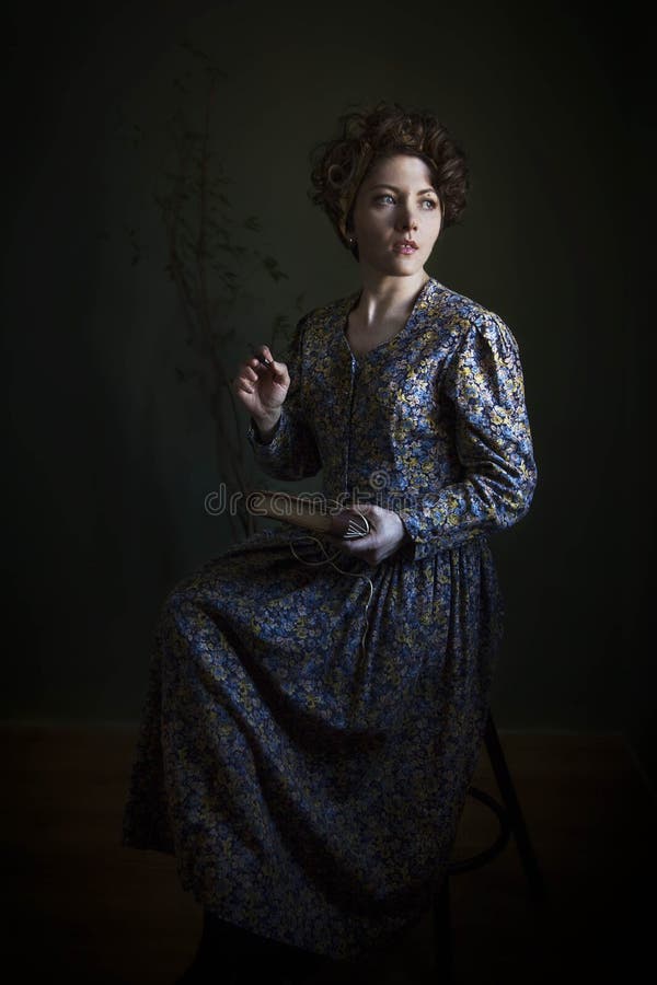 Portrait of a young woman in a beautiful English dress. The light scheme of Rembrandt, where the only light source - light from th. Portrait of a young woman in royalty free stock images