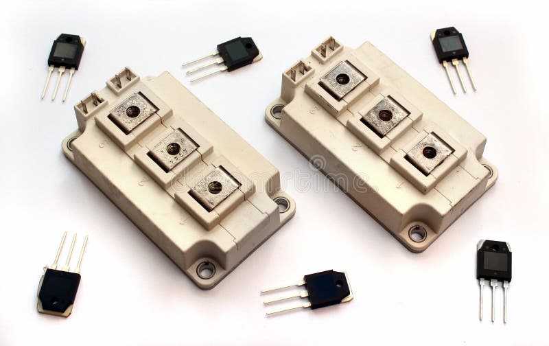 Powerful IGBT transistor modules and small transistors on white. Background stock photography