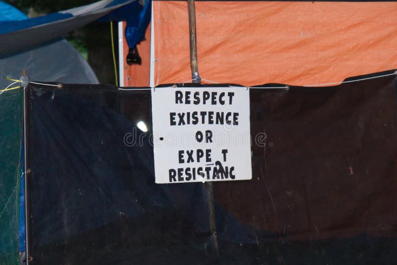 View of sign `Respect existence or expect resistance` in Strathcona Park full of tents and homeless people. Vancouver,Canada - June 26,2020: View of sign ` stock images