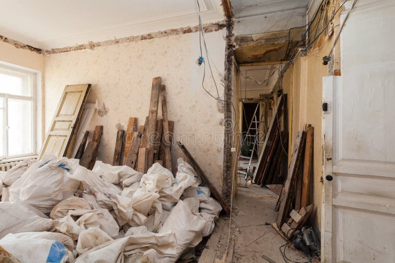 View room of the apartment and retro chandelier during under renovation, remodeling and construction. The process of disassembly old room and packing royalty free stock image