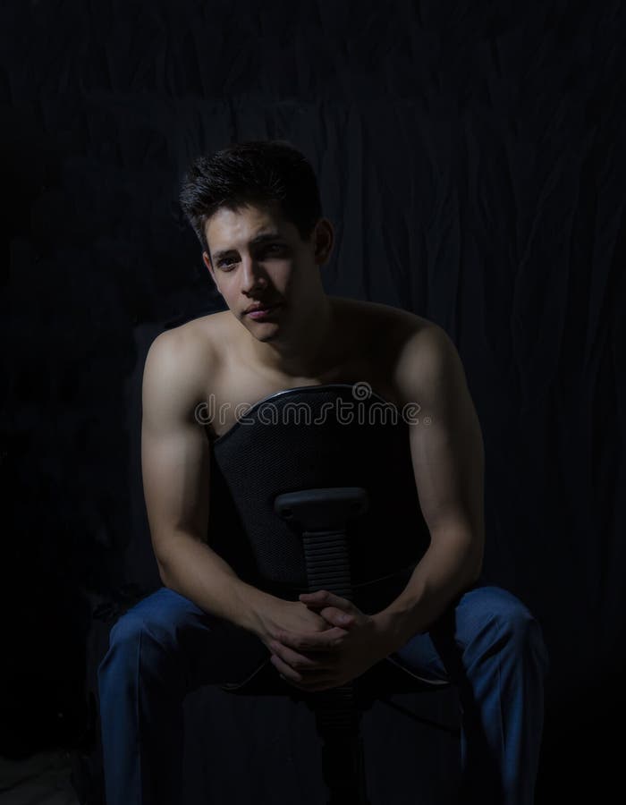 Young model sitting and with a lighting scheme rembrandt. Rembrandt is considered one of the masters of light in painting. His recognition is such that there is royalty free stock image